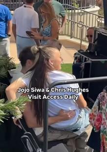Jojo Siwa sitting on Chris Hughes' lap on Access Daily.