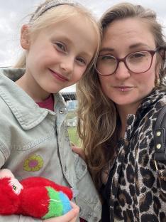 A woman and young girl posing for a selfie.