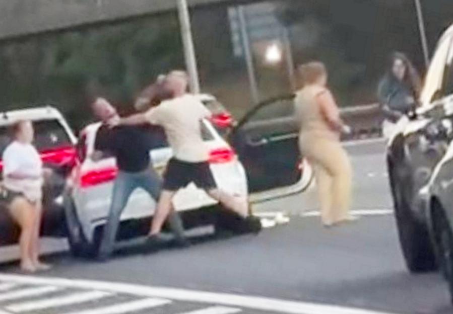 Shocking moment woman drags driver from her car by the HAIR during ‘road rage brawl’ on packed motorway