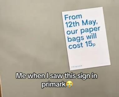 Primark sign announcing 15p paper bag cost.