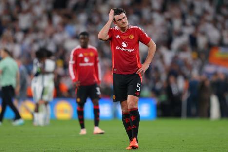 Harry Maguire of Manchester United looking dejected on the field.