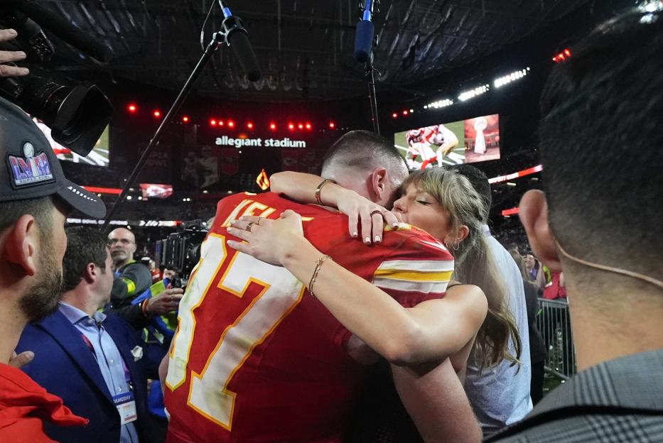 Taylor Swift embracing Travis Kelce after Super Bowl 58.