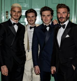 David Beckham with his sons Romeo, Cruz, and Brooklyn in tuxedos.