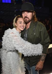 Miley Cyrus and Billy Ray Cyrus hugging at the Billboard Music Awards.