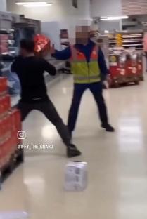A shoplifter throws crates at a security guard in a Tesco store.