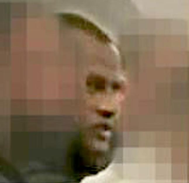 Pixilated close-up of Hadush Kebatu on his deportation flight.