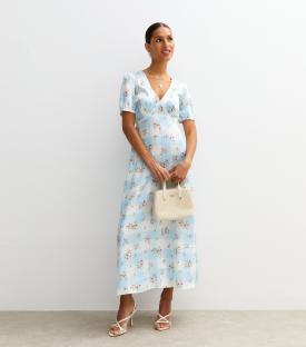 Woman in blue and white floral gingham maxi dress.