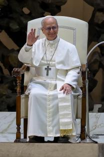 Pope Leo XIV waving to people.