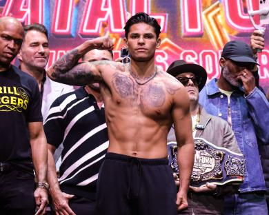 Ryan Garcia flexing at a boxing weigh-in.