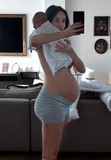 Woman holding newborn baby, one week postpartum.
