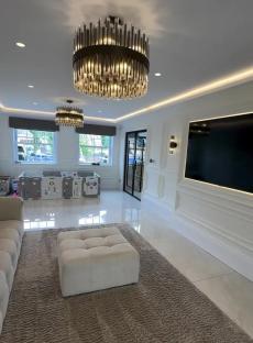 Playroom with large TV and plush rug.