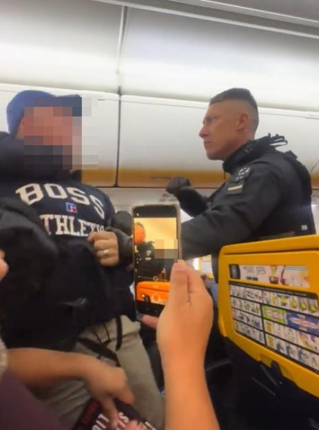 Shocking moment boozy Brit stag do yobs are dragged off Ryanair flight by armed cops after emergency landing