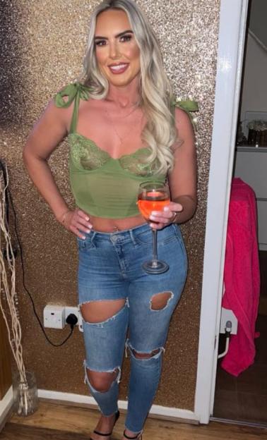 Woman holding a glass of wine.