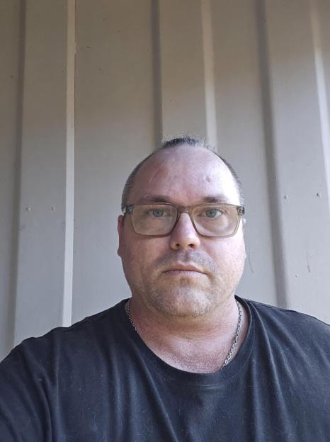 Photo of a man wearing glasses.