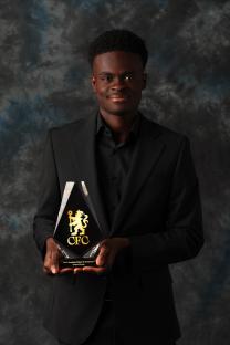 Tyrique George holding his Chelsea Men's Academy Player of the Season award.