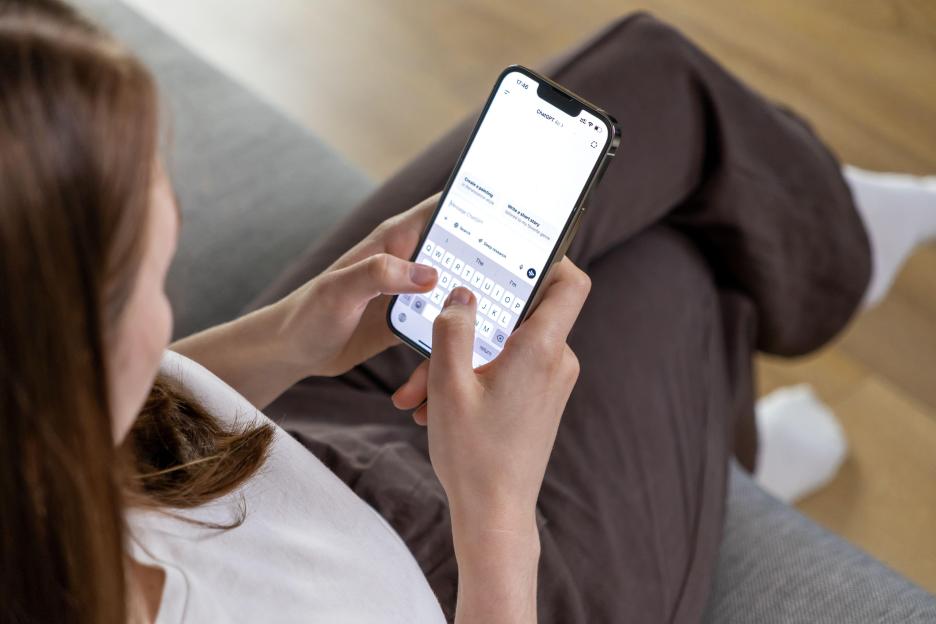 Woman using ChatGPT app on her phone.