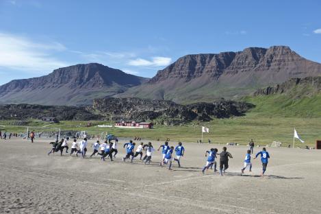 Greenlandic boys playing soccer near Qeqertarsuaq.