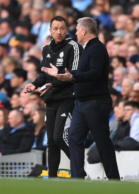 John Terry and Dean Smith, manager of Leicester City, at a soccer match.