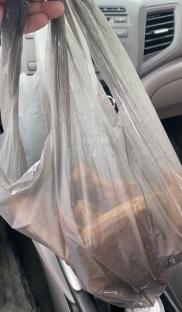 Pizza slices in a plastic bag.