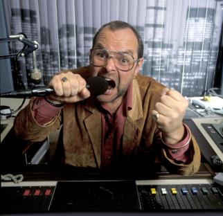 James Whale at a radio microphone.