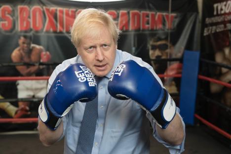 Boris Johnson wearing boxing gloves that say