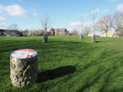 Queenborough Castle information sign in a park.