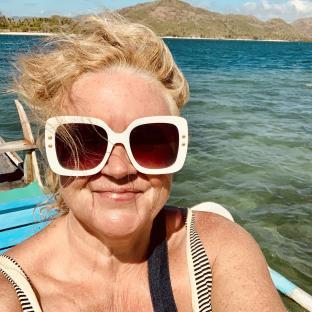 Woman wearing sunglasses on a boat.