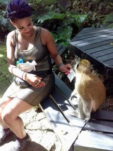 Woman feeding a monkey.