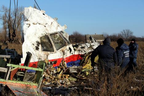 Workers recovering wreckage from the Malaysia Airlines Flight 17 crash site.