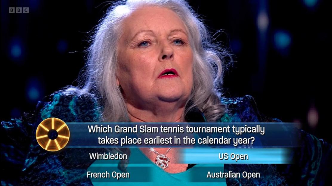 Screenshot of a woman on *The Wheel* game show answering a tennis question incorrectly.