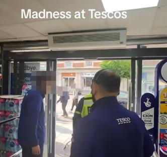 Security guards evicting shoppers from a Tesco store.