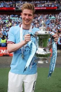 Kevin De Bruyne of Manchester City holding the FA Cup trophy.