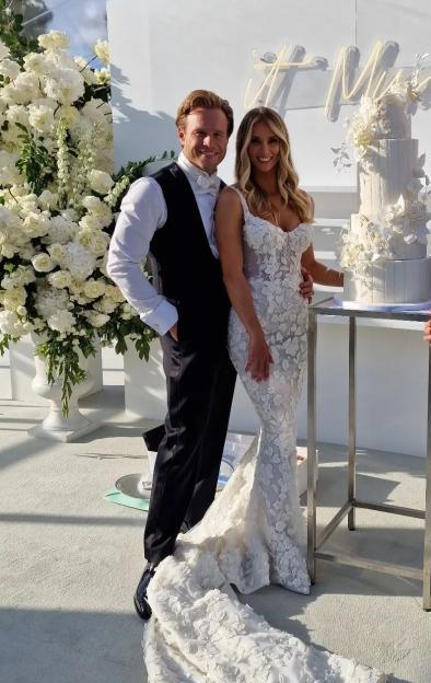 Bride and groom posing for a wedding photo.