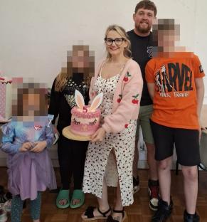 Family photo with birthday cake.