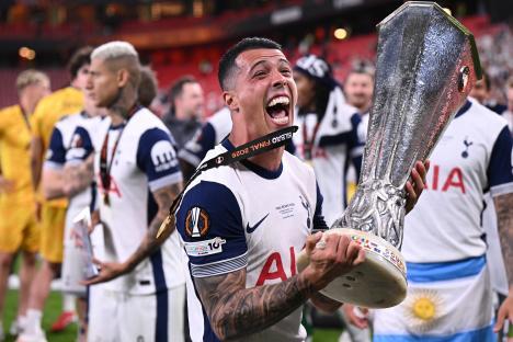 Pedro Porro of Tottenham Hotspur celebrating with the UEFA Europa League trophy.