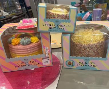 Three M&S birthday cakes: vanilla sprinkle, rainbow layer, and under the rainbow.