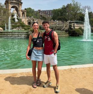 Couple posing by a fountain.