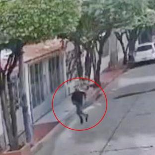 Video still of a man running away after a shooting.
