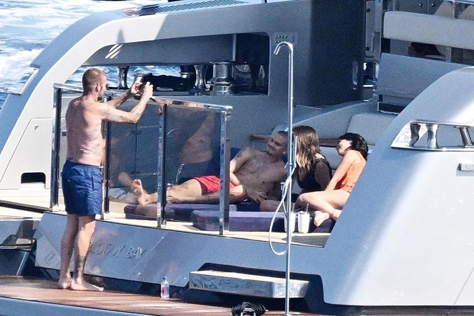 David and Victoria Beckham with family and friends relaxing on a yacht.