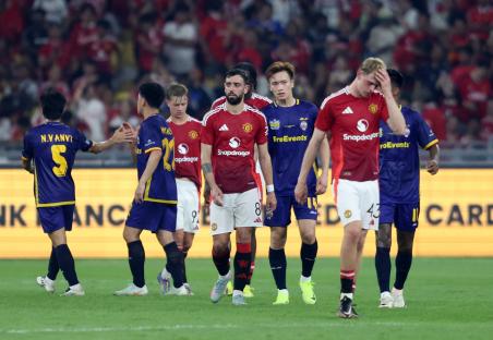 Manchester United's Bruno Fernandes and other players after a soccer match.