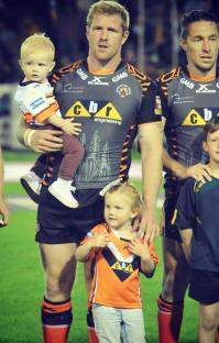 Rugby player with his two young children.