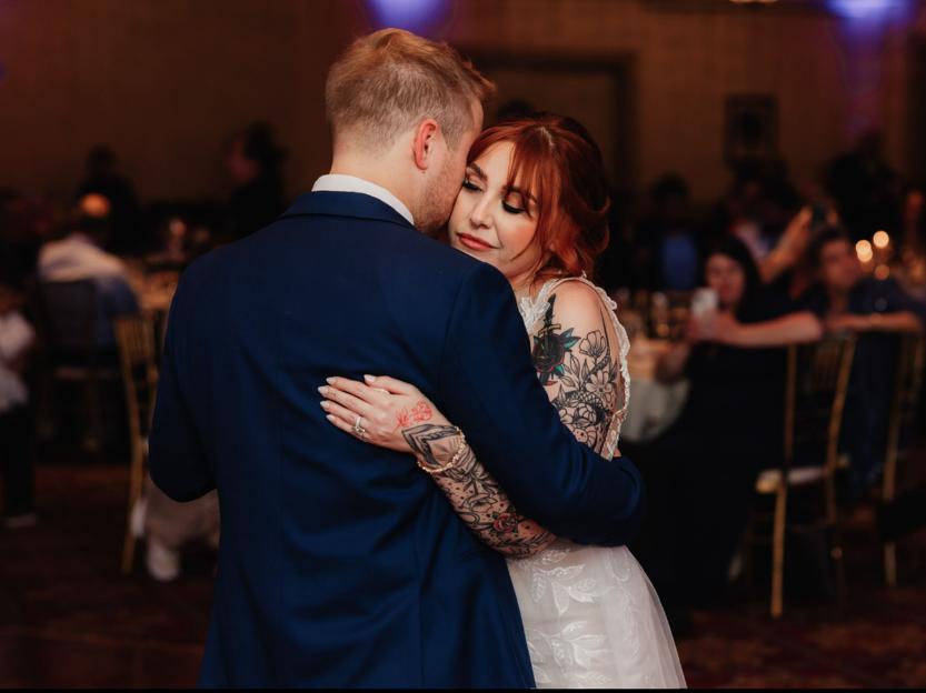 Bride and groom embracing at their wedding reception.