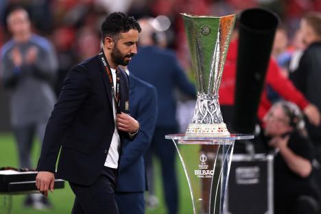 Ruben Amorim, Manchester United manager, walks past the UEFA Europa League trophy.