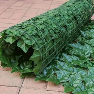 Artificial ivy privacy screen rolled out on patio.