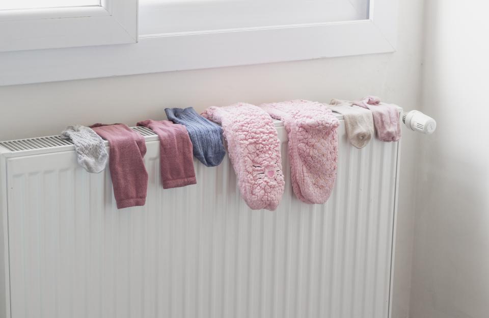 Socks drying on a radiator heater in a home.