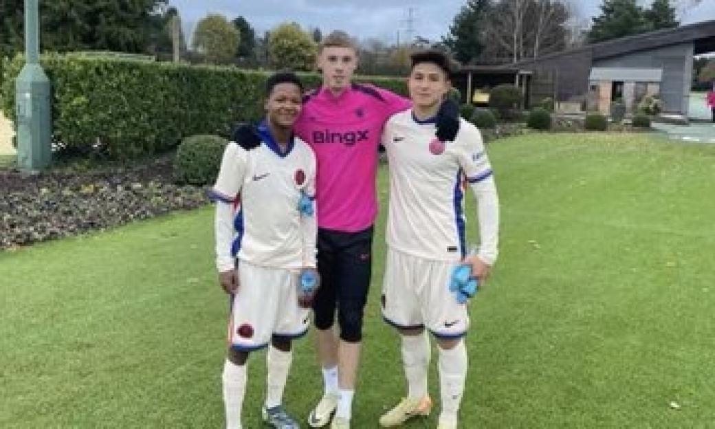 Three soccer players posing for a photo.