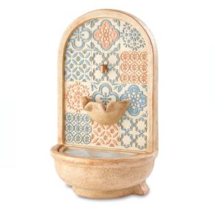 Aldi outdoor wall fountain with patterned tile design.