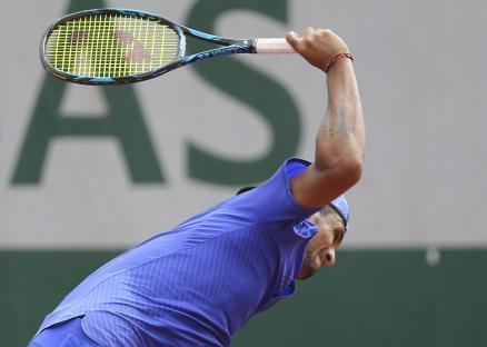 Nick Kyrgios breaking his tennis racket.