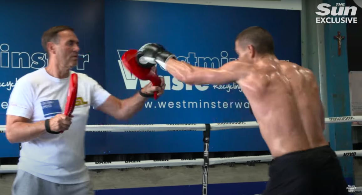 Boxer training with a coach.
