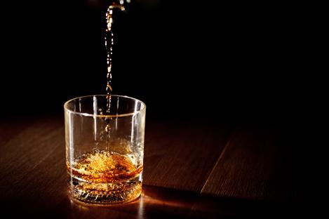 a glass of whiskey is being poured into it